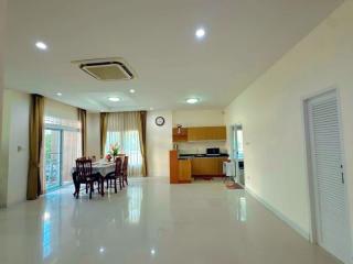 Spacious living area with dining set and open concept kitchen