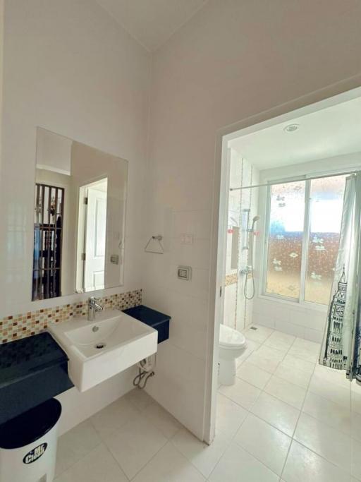 Bright bathroom with shower and outdoor access