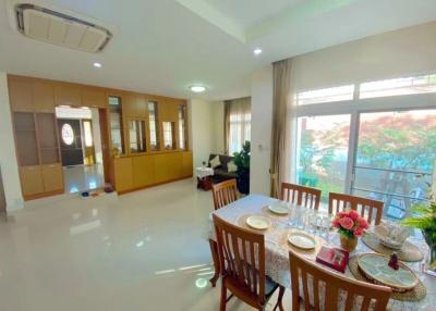 Bright and elegant dining room with large windows and glossy tiled floor