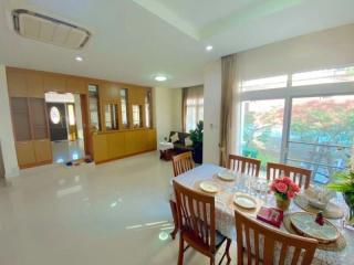 Bright and elegant dining room with large windows and glossy tiled floor