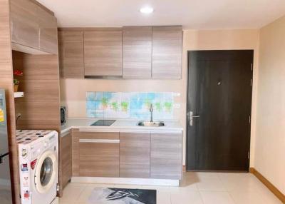 Modern kitchen with wooden cabinets and white appliances