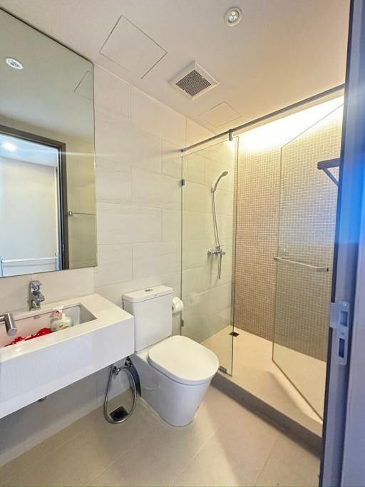 Modern bathroom with glass shower and white tiles