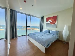 Bright coastal bedroom with ocean view and modern decor