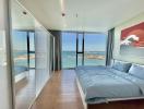 Modern bedroom with ocean view through floor-to-ceiling windows