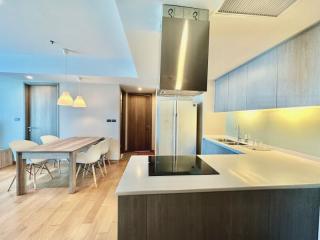 Modern kitchen with integrated appliances and dining area