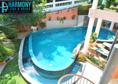 Spacious outdoor area with swimming pool and greenery