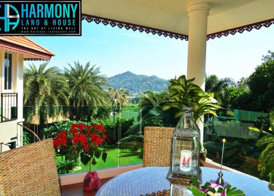 Spacious balcony with mountain view and lush greenery