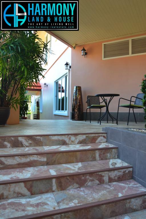 Spacious outdoor patio area with steps leading to the living space
