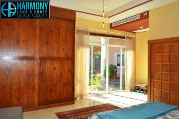 Spacious bedroom with wooden wardrobe and direct access to balcony