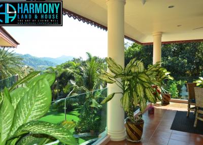 Spacious balcony with seating and mountain view