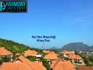 Panoramic view of Sai Noi Beach at Khao Tao with surrounding houses and lush hills