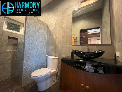 Modern bathroom interior with grey tiles and elegant fixtures