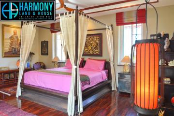 Elegant master bedroom with traditional decor and hardwood flooring