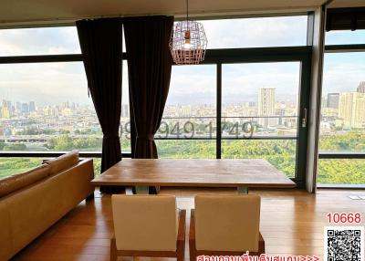 Spacious living room with large windows and city view