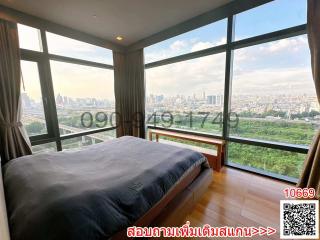 Modern bedroom with large windows offering a panoramic city view