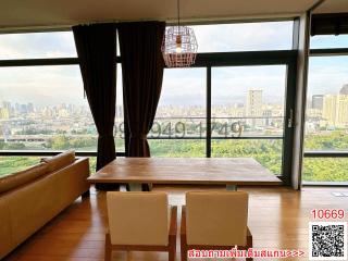 Elegant living room with expansive city view through floor-to-ceiling windows