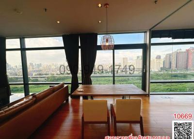 Spacious living room with large windows overlooking the city skyline
