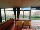 Spacious living room with large windows overlooking the city skyline