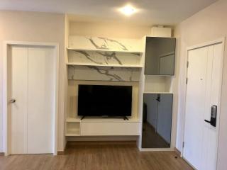 Modern living room interior with mounted television and shelving