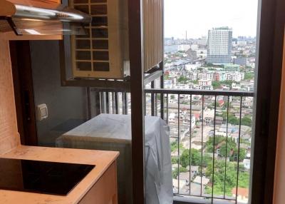 Compact kitchen corner with a view of the city overlooking a busy urban area