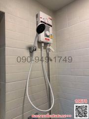 Electric water heater with shower head in bathroom