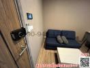 Compact living room with modern sofa and digital security door lock