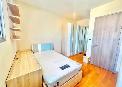 Bright bedroom with wooden furniture and parquet floor