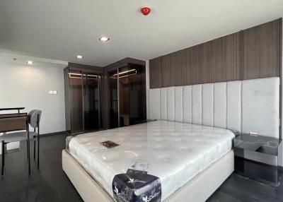 Spacious bedroom with large bed and modern furnishings