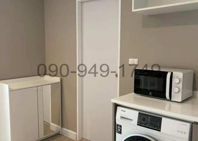 Modern utility room with washing machine and microwave