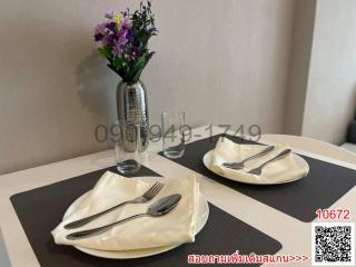 Elegant dining table set up with silverware and a flower vase