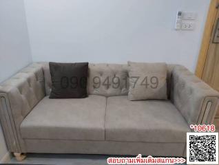 Beige sofa in a modern living room with QR code and contact number