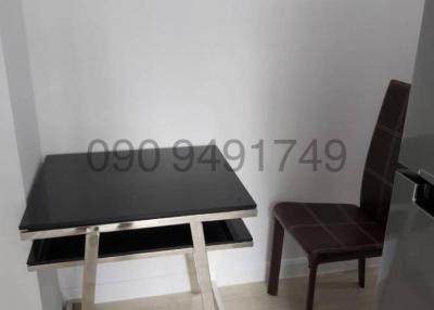Small workspace area with a modern black table and one chair