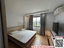Spacious Bedroom with Large Windows and Modern Amenities