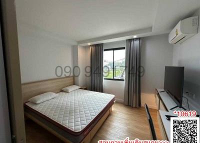 Spacious Bedroom with Large Windows and Modern Amenities