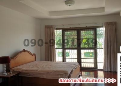 Spacious bedroom with natural light and air conditioning