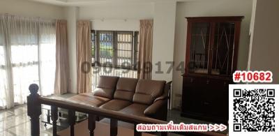 Spacious living room with natural light and classic furniture