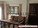 Spacious living room with natural light and classic furniture