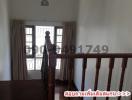 Spacious upper-level hallway with wooden banister and large windows