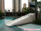 Modern outdoor swimming pool with cityscape view and a waterslide