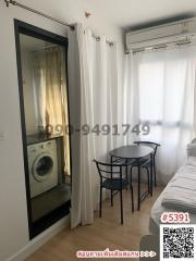 Compact bedroom with washing machine, air conditioning, and dining area