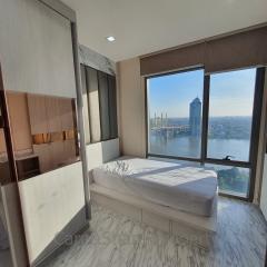 Modern bedroom with large window offering a city view