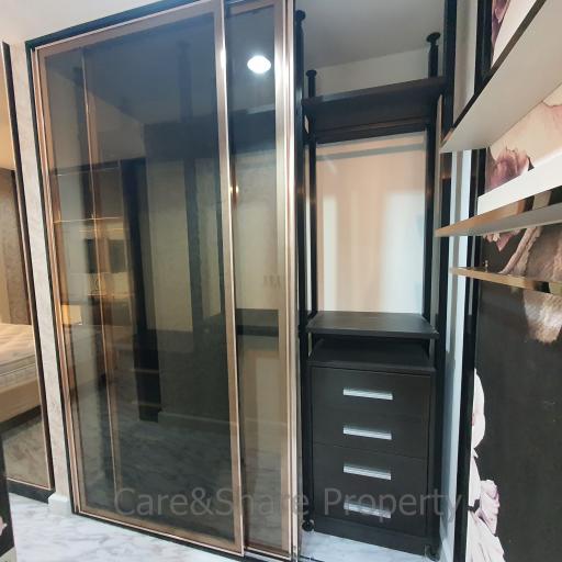 Modern bedroom with large mirrored wardrobe and sleek black dresser
