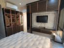 Modern bedroom interior with television and wardrobe