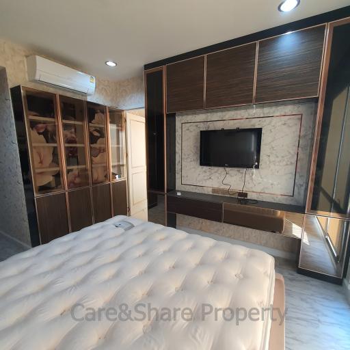 Modern bedroom interior with television and wardrobe
