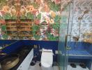 Colorful tropical-themed bathroom with a walk-in shower and artistic wallpaper