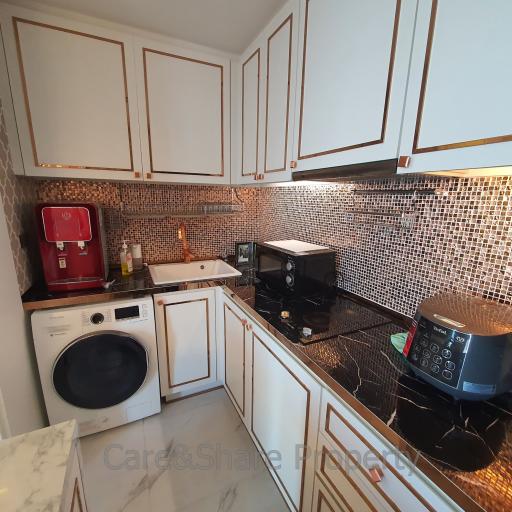 Compact kitchen with modern appliances and mosaic backsplash