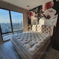Elegant bedroom with a large comfortable bed and a scenic city view