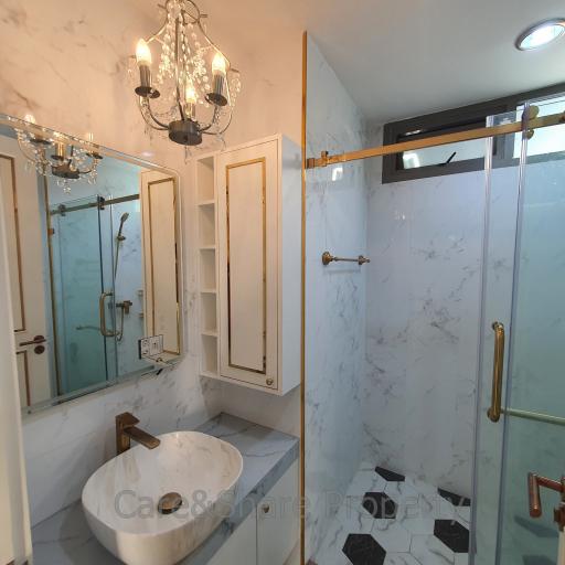 Modern bathroom with glass shower and marble finishes