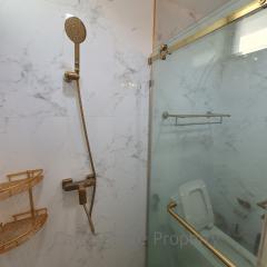 Modern bathroom with marble tiles and glass shower