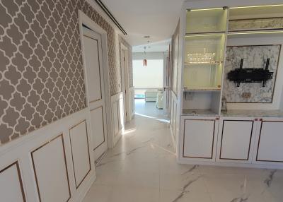 Modern kitchen with marble flooring and patterned wall design